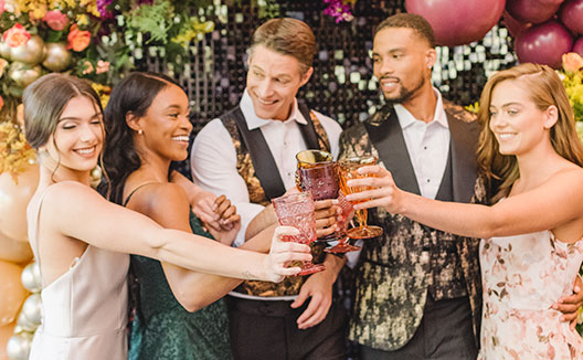 Group of guests cheersing at wedding